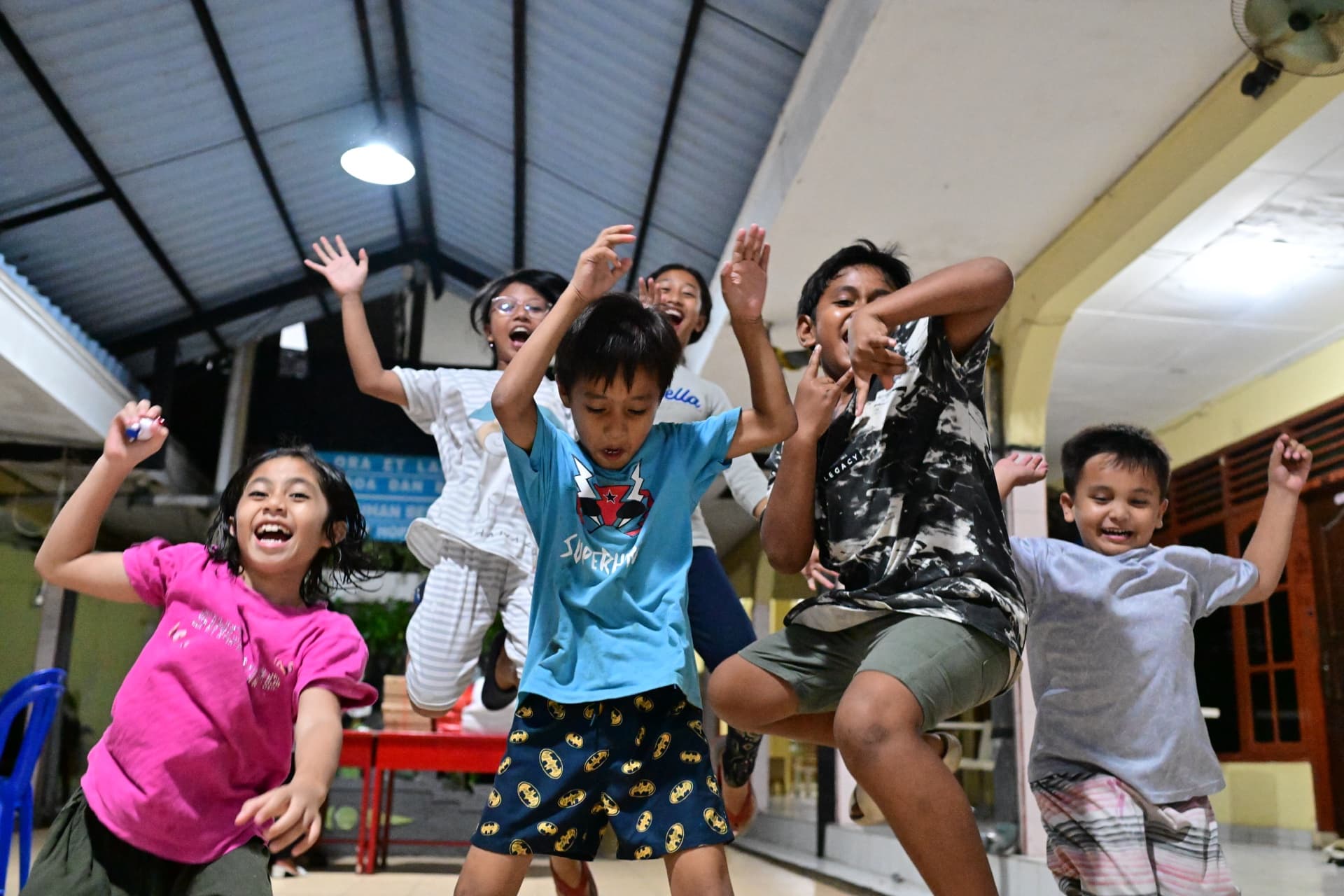 Kids jumping with joy at the orphanage